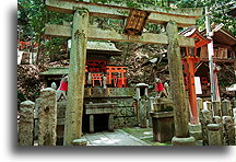 Altar and messenger foxes::Fushimi Inari Taisha Shrine in Kyoto, Japan::