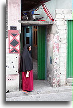 Lady at House Entrance::Male, capital city of Maldives::