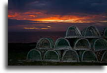 Lobster Pots at Sunset::Lobster traps stacked on the beach::