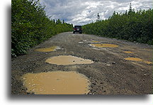 Road by Porrage Lake::The road had many potholes which forced be to drive slowly::